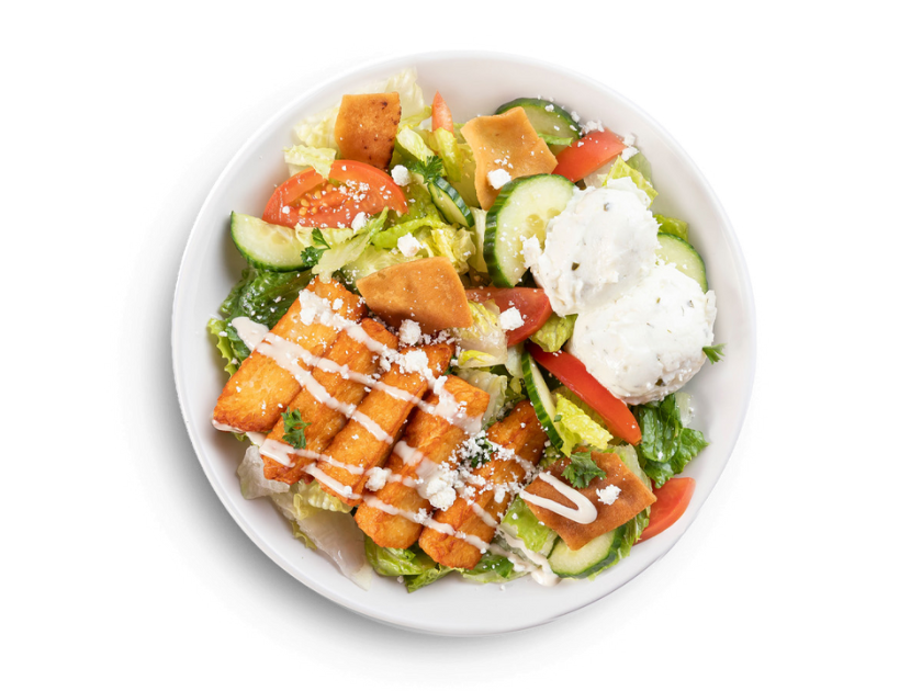 Halloumi salad with cucumbers, tzatziki, feta, pita chips, tahini, parsley, tomatoes and lettuce