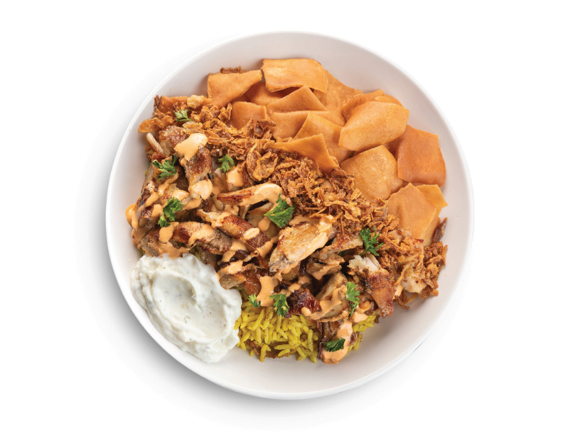 Chicken shawarma served over basmati rice with spicy garlic, tzatziki, onions, pita chips and parsley